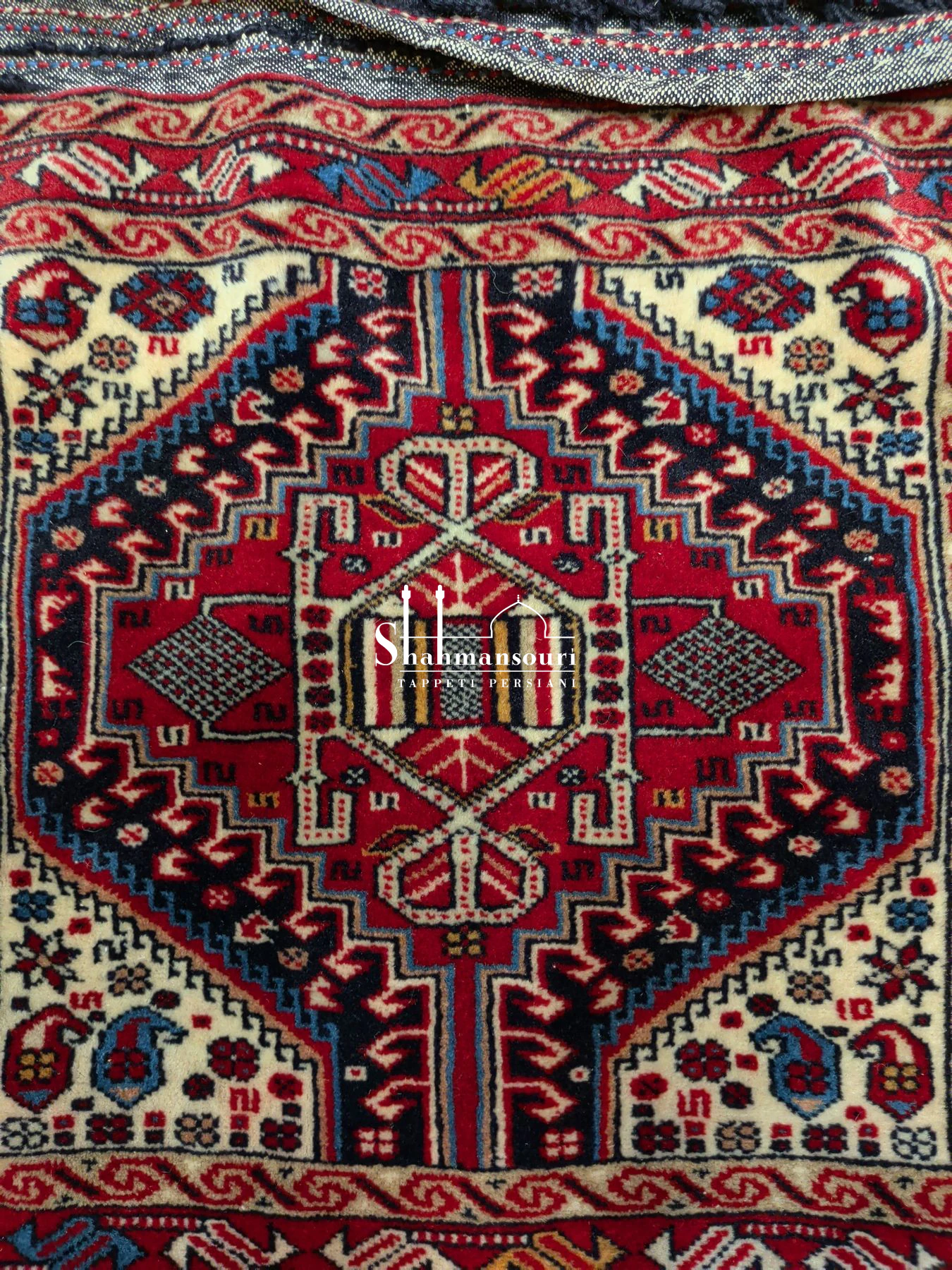 Open khorjin with two geometric medallion panels and a central multicoloured zigzag section. - detail 3