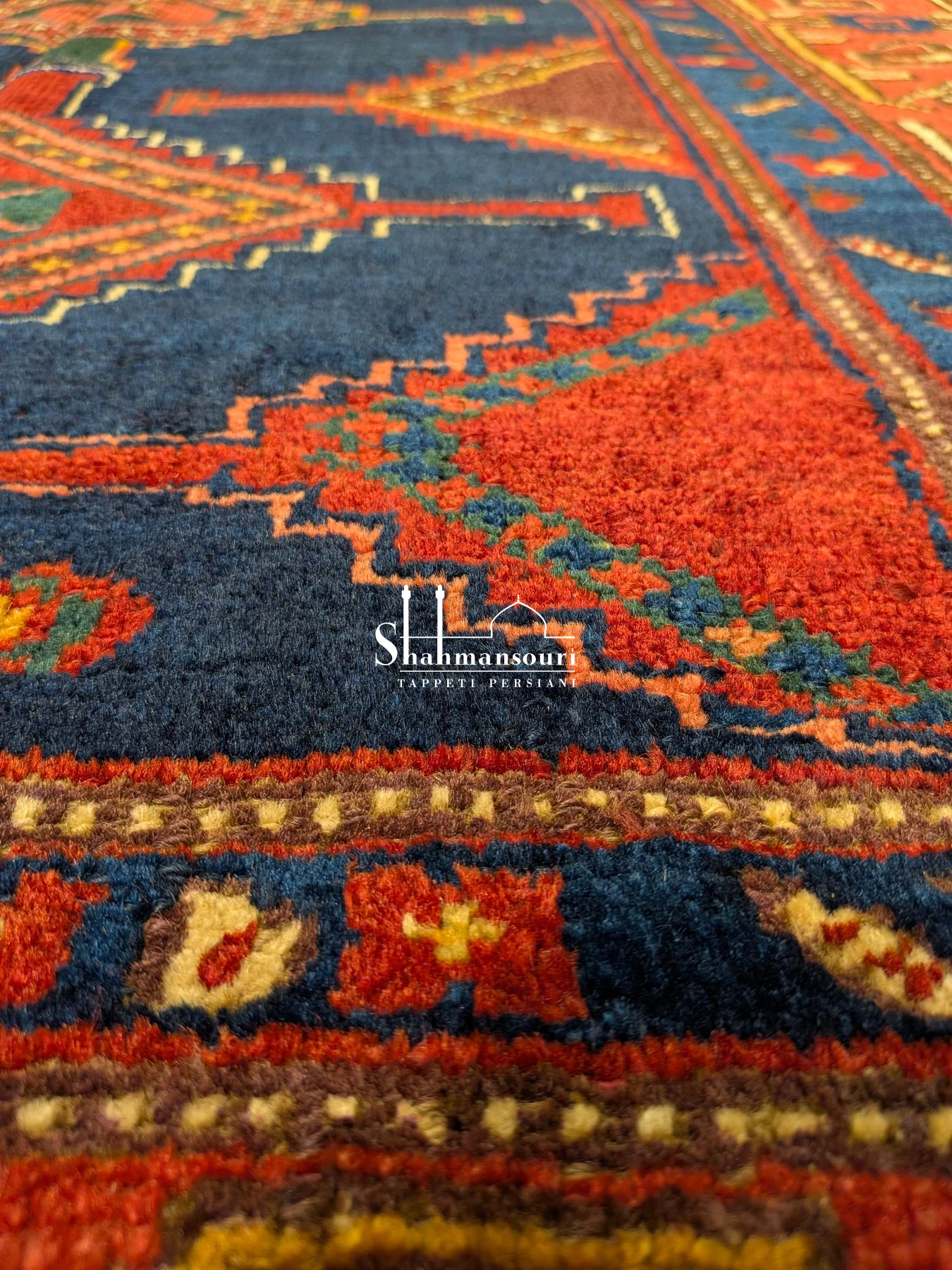 Kordi Persian wool rug with a dark blue field, four geometric medallions, red borders and pale fringes, 182 x 128 cm. - detail 2