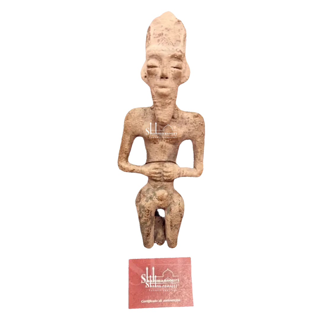 Persian maiolica statue of a stylised human figure with an elongated head, bent arms and a beige and brown surface.