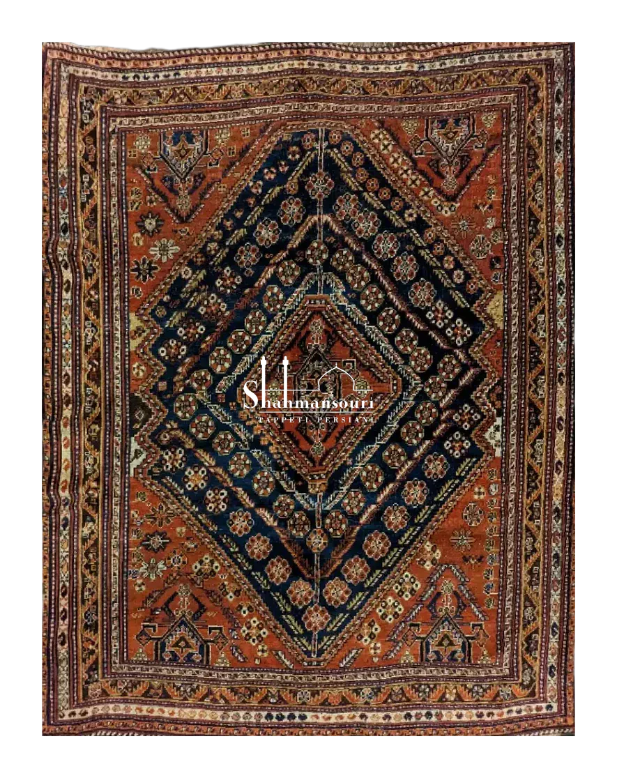 handmade Persian Qashqai rug with central geometric medallion on red background