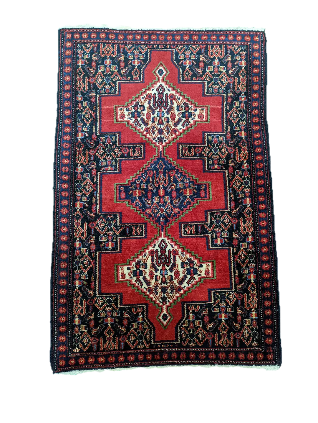 handmade Persian Senneh rug with geometric motifs and medallions on red background