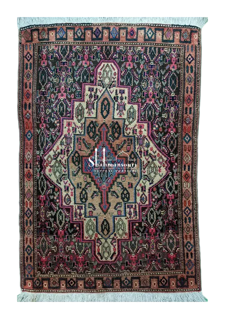 handmade Persian Senneh rug with geometric medallion on dark background