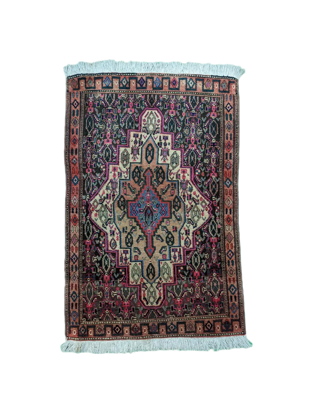 handmade Persian Senneh rug with geometric medallion on dark background